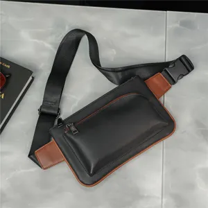 Detailed view of trendy men's black and brown crossbody chest bag, adjustable strap design.