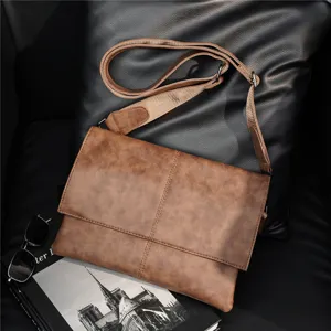 Detail shot of a brown vintage shoulder bag placed on a black cushion with a book and glasses.