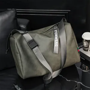 Detail shot of the dark green casual travel duffel bag showing strap buckle and hanging tag.