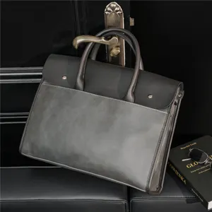 Detailed view of large capacity grey business briefcase with double handles and flap closure.