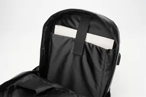 Dettaglio interno zaino nero con scomparto per laptop e tasca portaoggetti dal design pulito.