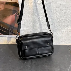Men black leather crossbody bag casual shoulder bag with front pocket and adjustable strap.