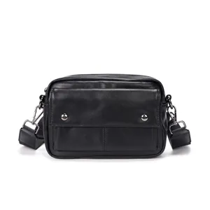 Detailed view of a stylish black leather men's crossbody bag with metal buttons and strap.