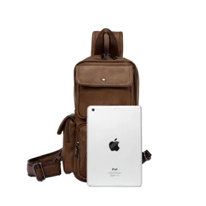 Detailed view of brown leather chest bag capacity showing multi-pocket design with iPad prop.