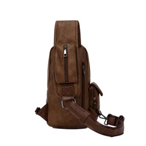 Men leather chest bag detail, brown sling backpack pocket and strap close up view