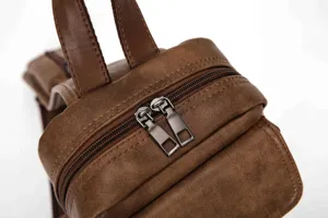 Men's vintage leather chest bag detail close-up, stylish casual crossbody backpack view.