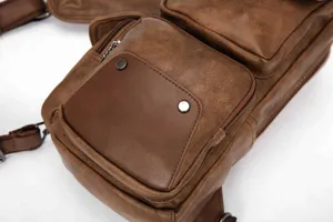 Men brown PU leather chest bag detail, casual multi-pocket sling crossbody backpack design.