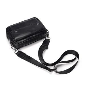 Detailed view of black leather men's crossbody bag with adjustable strap and metal hardware.