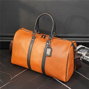 Detailed view of the premium brown leather travel duffel bag with durable black handles and strap.