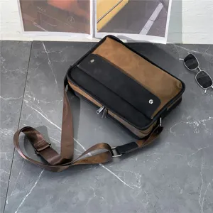 Detail shot of retro men's crossbody bag, brown and black color block, adjustable canvas strap.