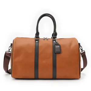 Detailed view of the vintage brown travel duffel bag with black vertical stripes and sturdy handles.