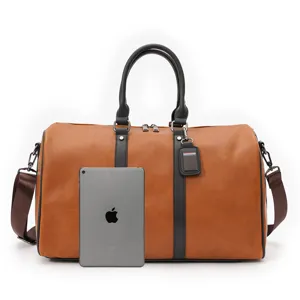 Men brown vintage duffel travel bag detail view with size reference tablet accessory.