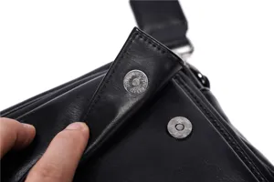 Close-up of black leather men's shoulder bag showing durable hardware and snap button.