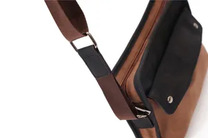 Detailed view of retro messenger bag strap and metal hardware buckle closeup design.