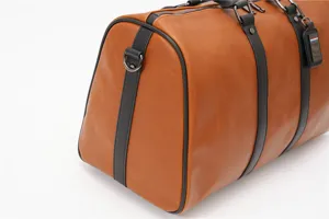 Brown leather travel duffel bag for men, large capacity vintage weekender bag for trips.