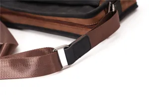 Detailed view of casual messenger bag strap and metal hardware with color-blocked design.
