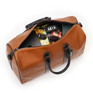 Detailed view of large capacity brown leather travel duffel bag open interior display.