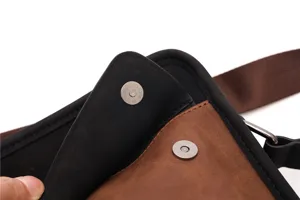 Detail view of men casual messenger bag magnetic snap button stitch craftsmanship.