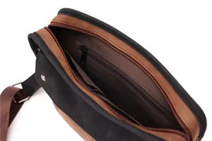 Detailed view of brown and black retro messenger bag interior structure and zipper pocket.