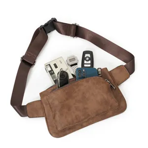 Detail shot of men brown frosted leather chest bag with front zipper pocket and strap.
