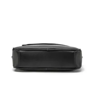 Detailed view of the bottom and structure of a black PU leather men's crossbody chest bag.