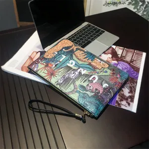Detailed view of the tropical jungle printed men clutch bag with zipper and wrist strap.