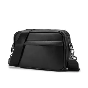 Black PU leather crossbody bag detail view, sleek texture and sturdy metal hardware.