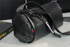 Black cylindrical leather shoulder bag, casual trendy crossbody barrel bag for daily use.