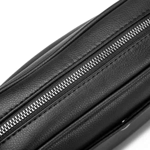 Close-up detail of black PU leather cross body bag zipper texture style design part view