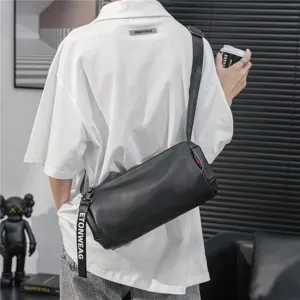 Black cylindrical crossbody bag for men, stylish casual single shoulder bag with trendy design.