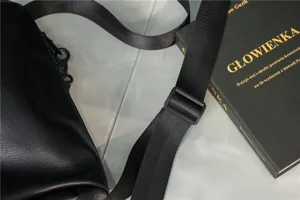 Close-up detail of the durable black nylon shoulder strap and adjustable buckle on a casual bag.