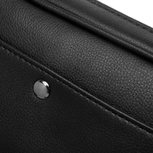 Close-up detail of black PU leather men chest bag showcasing texture, stitching and metal snap.