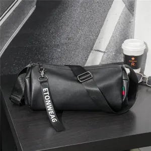 Stylish black cylindrical crossbody bag for men and women, casual lightweight shoulder bag.