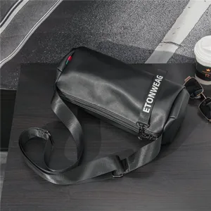 Stylish black cylindrical crossbody bag with trendy strap detail for men and women daily use.