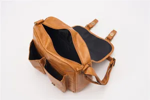 Detailed view of the vintage brown leather crossbody messenger bag with front pockets and zipper.
