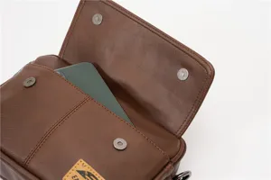 Vintage brown leather crossbody messenger bag with flap closure and convenient front pocket.