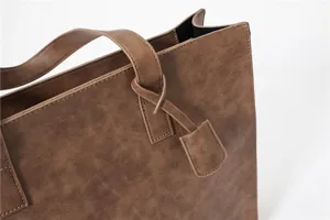 Brown PU leather tote bag casual minimalist handbag shoulder bag with handle and tag detail.