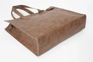 Brown PU leather tote bag side detail, casual minimalist shoulder handbag for daily commuting.