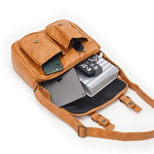Vintage brown leather crossbody bag with multiple front pockets and large storage capacity.