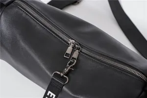 Minimalist black cylinder crossbody bag for casual daily use, lightweight stylish shoulder bag.