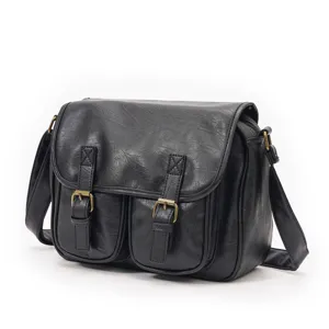 Classic black retro leather messenger bag with dual front pockets for casual daily streetwear use.