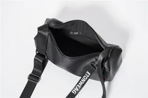 Black cylindrical crossbody bag detail view, casual PU leather shoulder bag with strap.