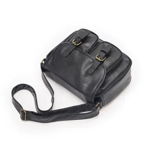 Black vintage leather crossbody bag with dual front pockets and adjustable strap for daily use.