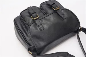 Black retro PU leather shoulder bag with front double pockets and brass hardware for men.