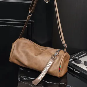Minimalist brown cylindrical crossbody bag for daily casual fashion use with adjustable strap.