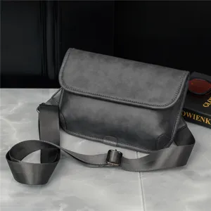 Detailed view of dark gray men's vintage messenger bag, durable fabric and adjustable strap.