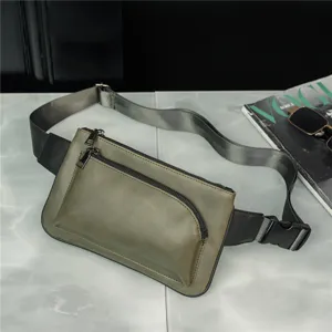 Detail view of the army green tactical chest bag showcasing multiple zippers and adjustable strap.