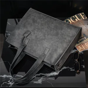 Detailed close-up view of the dark grey PU leather tote bag on a black marble surface.