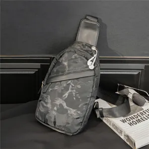 Close up view of stylish camouflage chest bag, trendy men sling bag with durable strap.