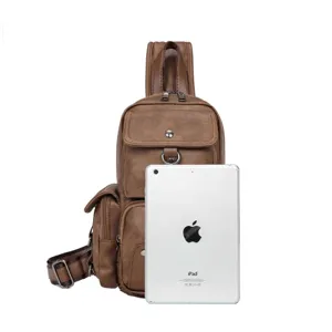 Detailed view of brown leather chest bag with multiple zipper compartments, ideal for casual wear.